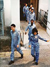 Astronauts exit the O&C Building.