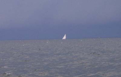 White Sail Against Storm Cloud