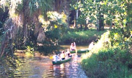 The happy canoers paddle around the next bend. 